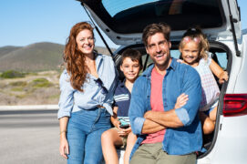 Family sitting in their car hire at Alicante airport